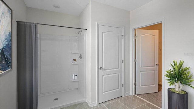 bathroom with tile patterned floors and walk in shower