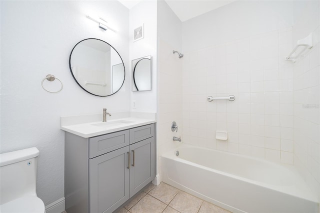 full bathroom with tile patterned floors, toilet, vanity, and tiled shower / bath