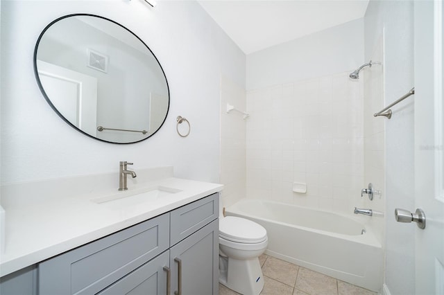 full bathroom with tile patterned flooring, vanity, toilet, and tiled shower / bath