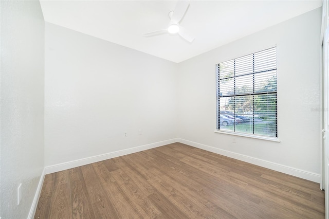 spare room with hardwood / wood-style floors and ceiling fan