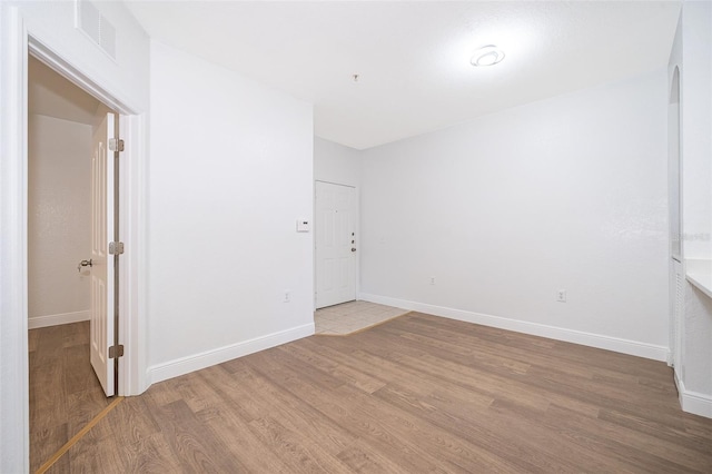 unfurnished room with hardwood / wood-style floors