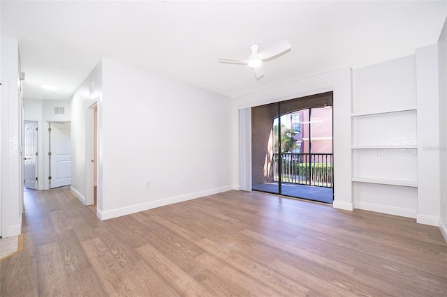 unfurnished room featuring ceiling fan, light hardwood / wood-style floors, and built in features