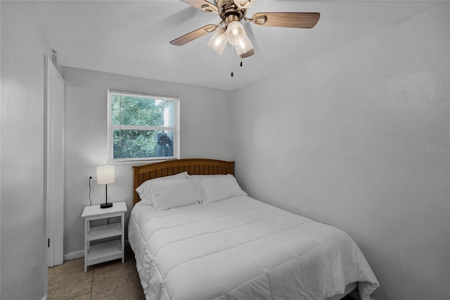 tiled bedroom with ceiling fan