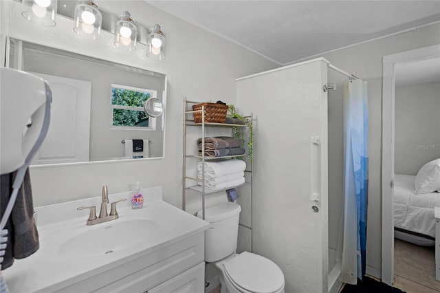 bathroom featuring a shower with curtain, vanity, toilet, and tile patterned floors