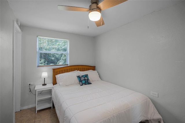 tiled bedroom with ceiling fan