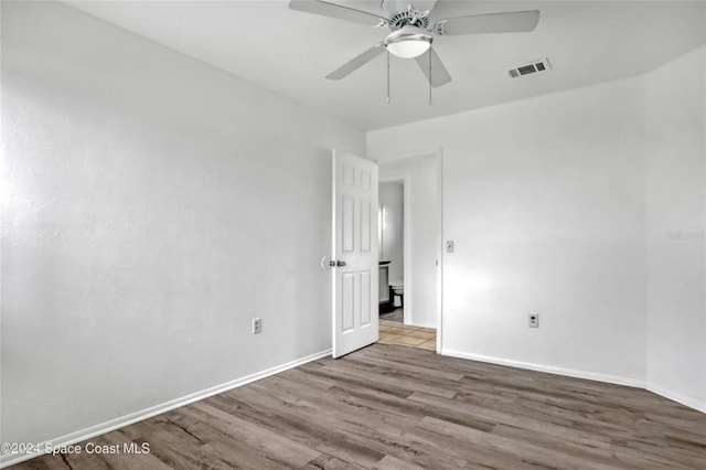 empty room featuring ceiling fan and light hardwood / wood-style floors