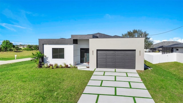 contemporary home featuring a garage and a front lawn