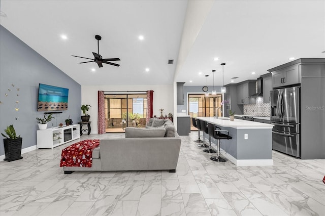 857 S Atmore Cir, Deltona, FL 32725 - living room featuring recessed lighting, ceiling fan, light marble finish flooring, and high vaulted ceiling