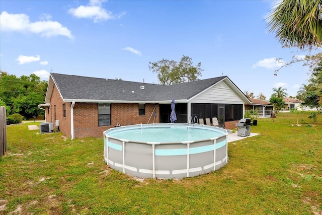 857 S Atmore Cir, Deltona, FL 32725 - outdoor pool featuring a sunroom, a yard, and a grill