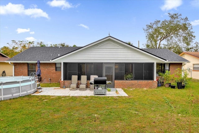 857 S Atmore Cir, Deltona, FL 32725 - back of property with a sunroom, brick siding, and a lawn