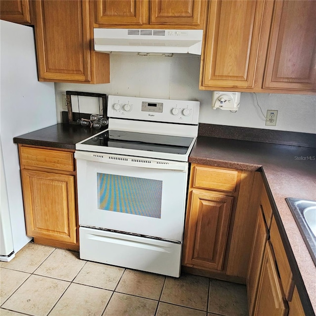 kitchen featuring light tile patterned flooring and white appliances