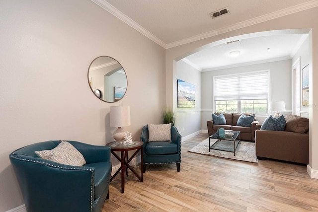 sitting room with hardwood / wood-style floors and ornamental molding