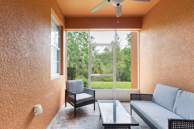 sunroom / solarium featuring ceiling fan and a healthy amount of sunlight