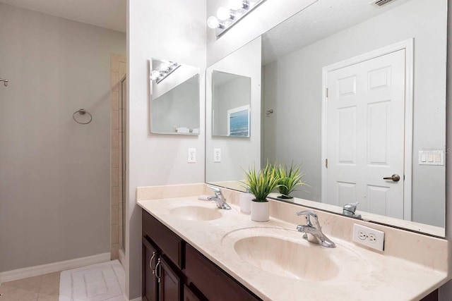 bathroom featuring a shower, vanity, and tile patterned floors