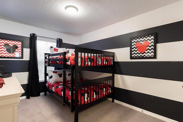 bedroom featuring carpet and a textured ceiling