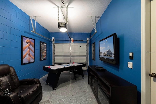 recreation room featuring a textured ceiling