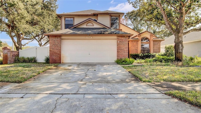 view of front property with a garage and a front yard