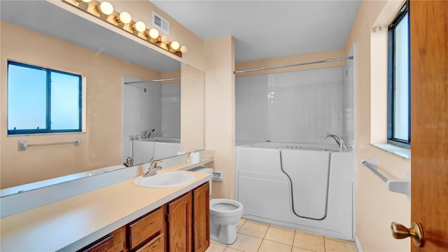 bathroom with tile patterned flooring, vanity, and toilet