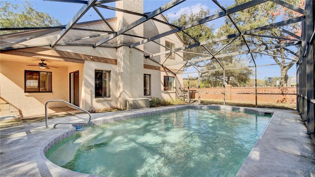 view of swimming pool featuring a lanai, a patio area, and ceiling fan