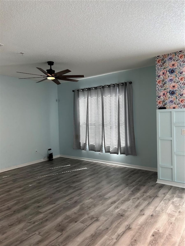 spare room featuring a textured ceiling, hardwood / wood-style flooring, and ceiling fan