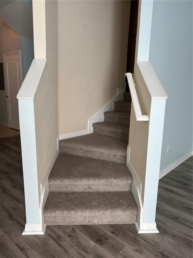 stairway with hardwood / wood-style flooring