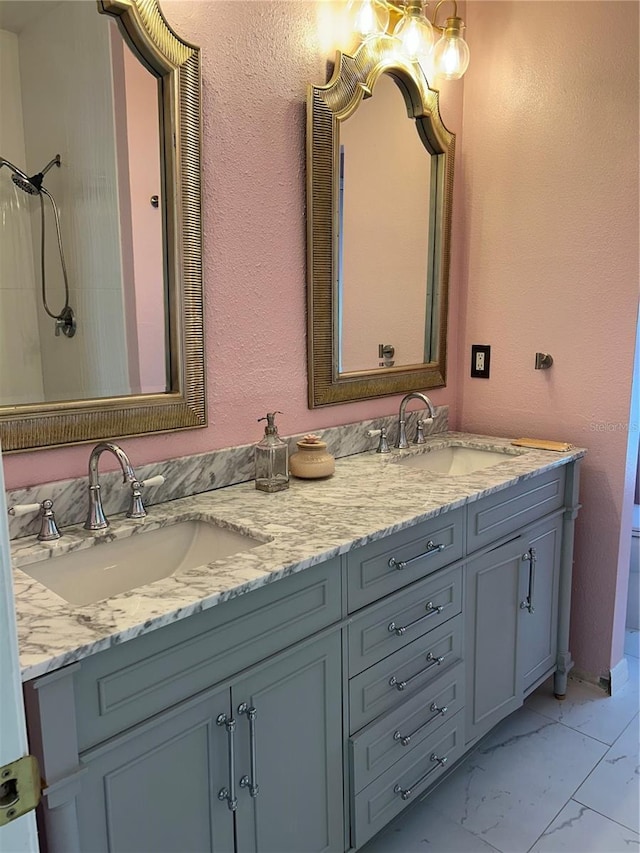 3031 San Jacinto Cir Unit 3031, Sanford, FL 32771 - bathroom with double vanity, marble look tile flooring, a textured wall, and a shower