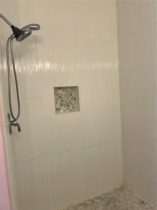 bathroom with a tile shower