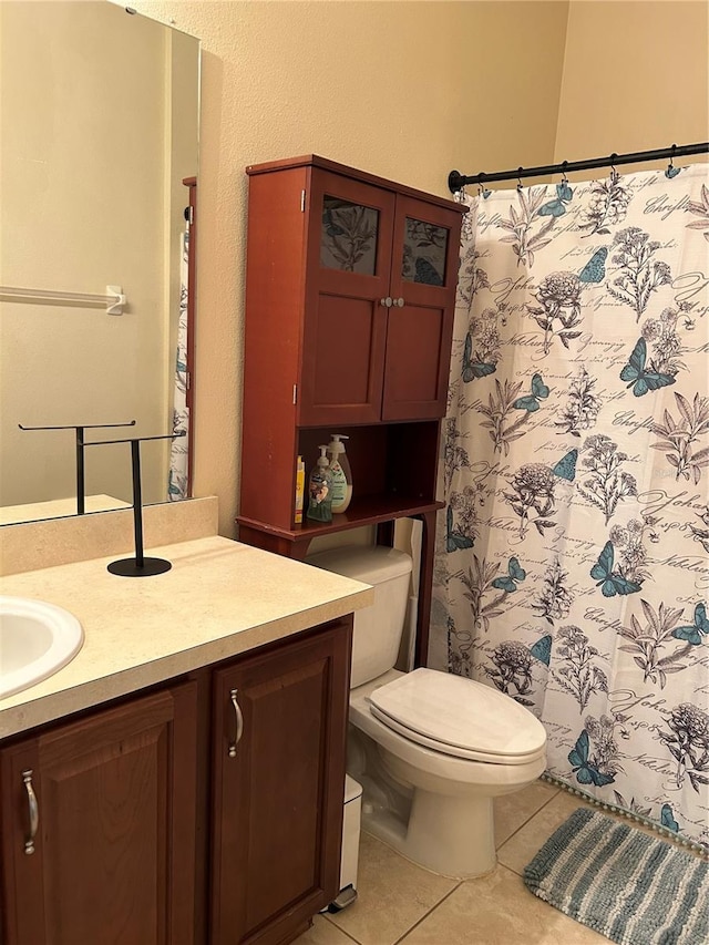 bathroom with tile patterned flooring, vanity, a shower with shower curtain, and toilet