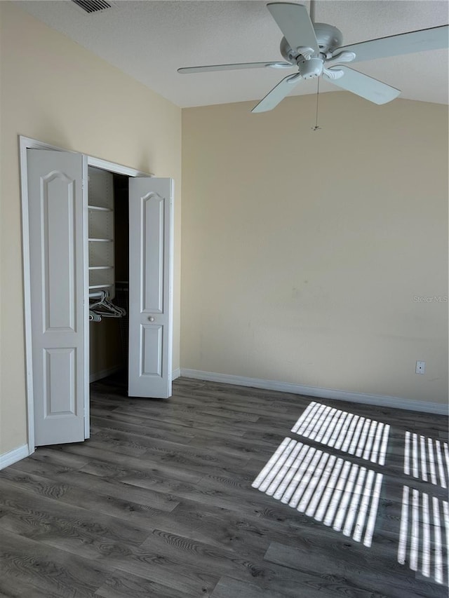 interior space with dark hardwood / wood-style flooring, ceiling fan, and a closet