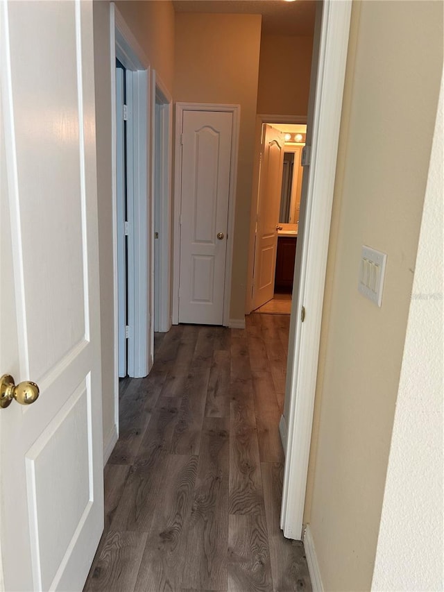 corridor with dark hardwood / wood-style floors