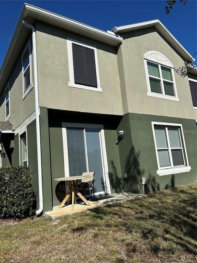 3031 San Jacinto Cir Unit 3031, Sanford, FL 32771 - rear view of house with stucco siding and a yard
