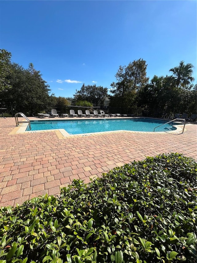 view of swimming pool with a patio area