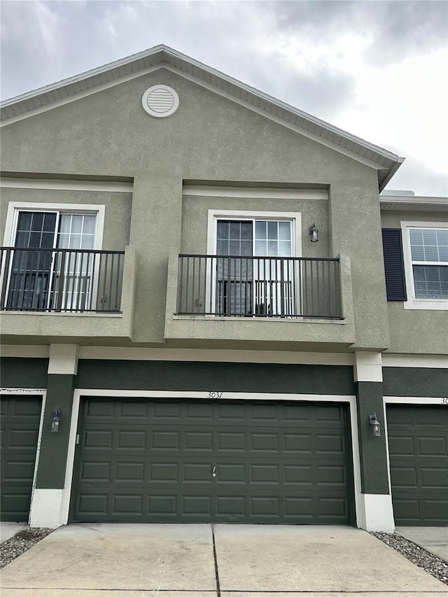 exterior space with a garage and a balcony