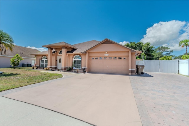 view of front of property featuring a front yard and a garage