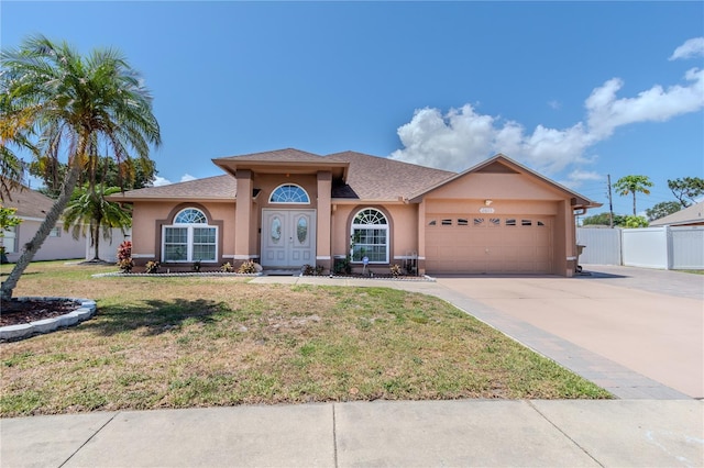 view of front facade featuring a front yard and a garage