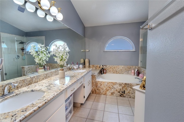 bathroom with tile patterned flooring, vanity, lofted ceiling, and independent shower and bath