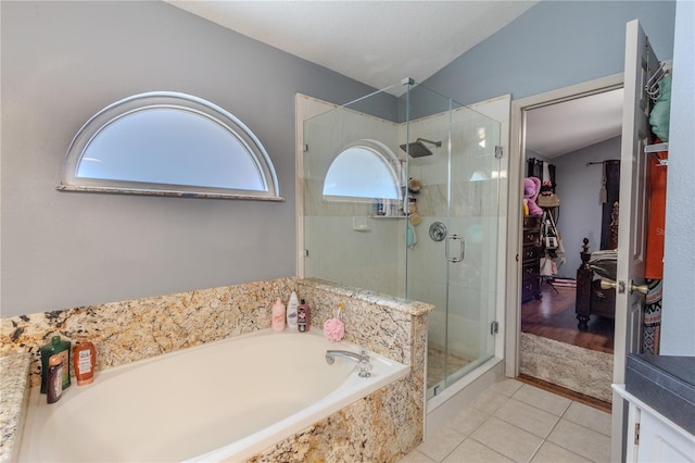 bathroom featuring tile patterned flooring, a healthy amount of sunlight, and lofted ceiling