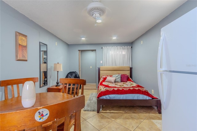 tiled bedroom featuring white refrigerator