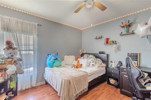 bedroom with ceiling fan and light hardwood / wood-style flooring