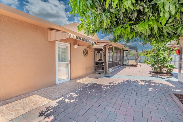 view of patio / terrace with a sunroom