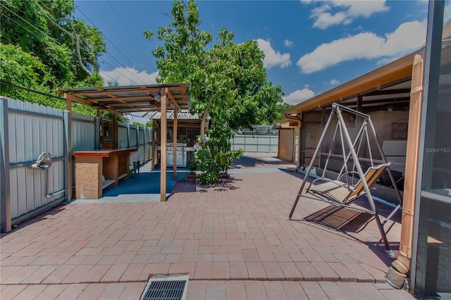 view of patio featuring an outdoor bar and grilling area