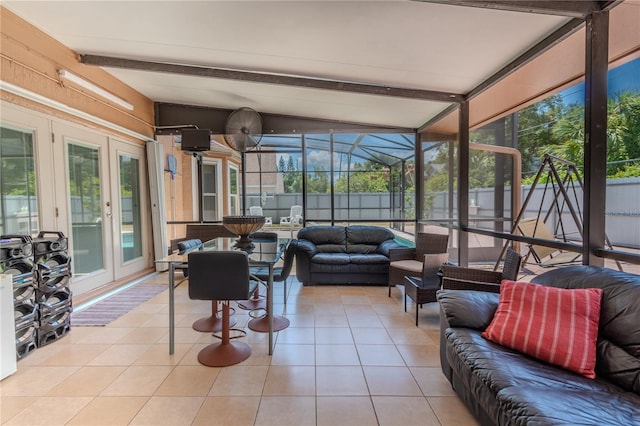 sunroom featuring vaulted ceiling with beams