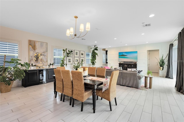 dining area with a chandelier and light wood-type flooring