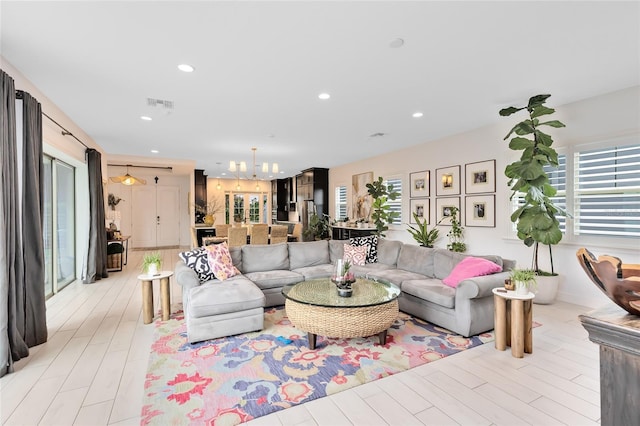 living room featuring light hardwood / wood-style flooring and an inviting chandelier