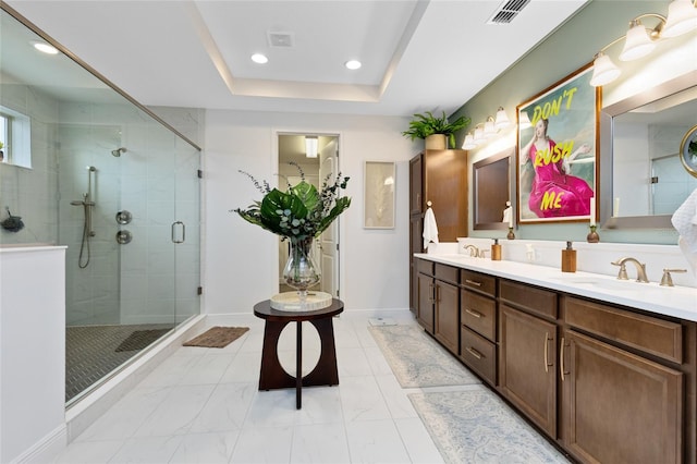 bathroom with vanity, an enclosed shower, and a tray ceiling