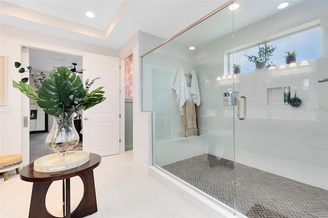 bathroom featuring walk in shower and a tray ceiling