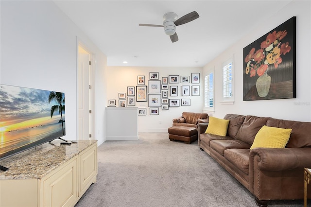 living room with light colored carpet and ceiling fan