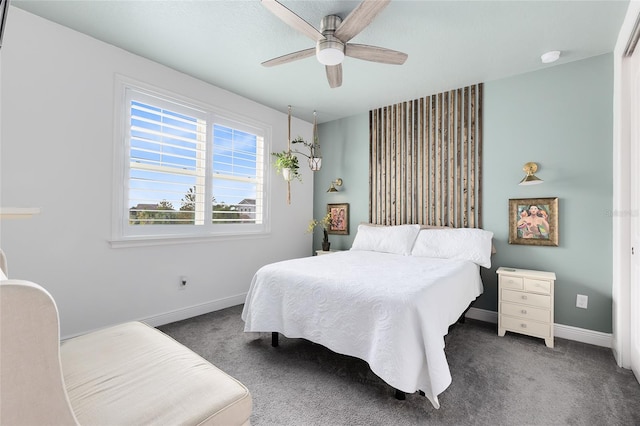 bedroom with dark colored carpet and ceiling fan