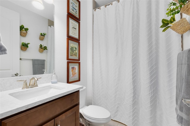 bathroom featuring tile patterned flooring, vanity, and toilet