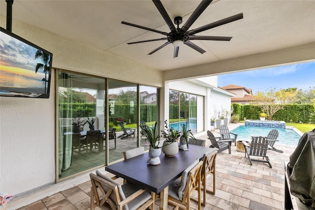 view of patio / terrace featuring ceiling fan and a pool with hot tub